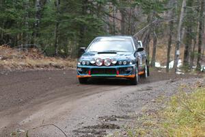 Mark Podoluch / Mariusz Malik at speed through a hard left-hander on SS1, Herman, in their Subaru Impreza.