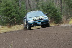 Erick Murray / Nicole Nelson head uphill at a fast left-hander on SS1 in their Subaru Legacy.