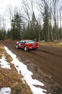 Craig Walli / Jonah Liubakka hang the tail out through the first fast uphill left-hander on Herman, SS1, in their Saturn SL-2.