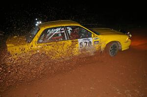 Erik Payeur / Adam Payeur sling loads of gravel upward at the final uphill left on Echo Lake 1, SS3, in their Mitsubishi Galant.