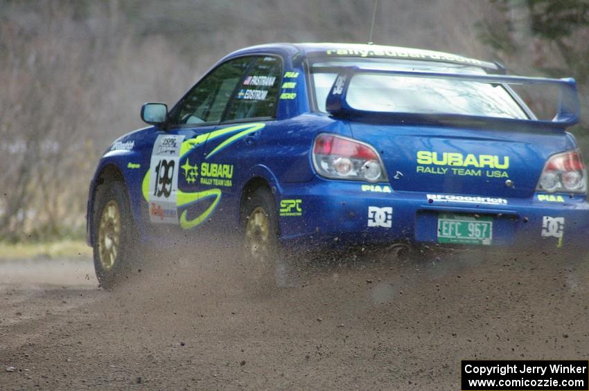 Travis Pastrana / Christian Edstrom drift at a hard left near the start SS1 in their Subaru WRX STi.