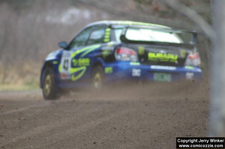 Ken Block / Alex Gelsomino drift at a hard left near the start SS1 in their Subaru WRX STi.