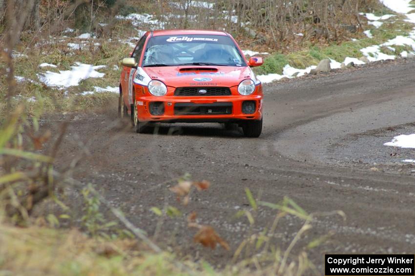 Matthew Johnson / Kim DeMotte at speed in the opening corners of SS1 in their Subaru WRX.