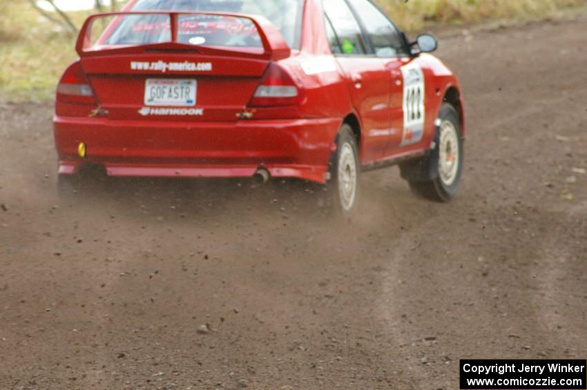 Dennis Martin / Alex Kihurani kick the back end of their Mitsubishi Lancer Evo IV around at a fast right-hander on SS1, Herman.