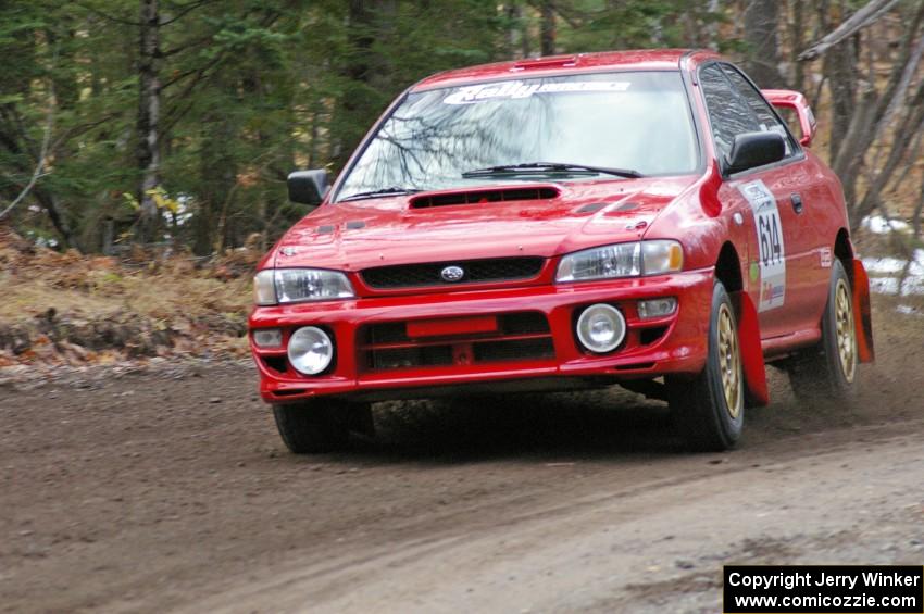 Piotr Wiktorczyk / John Nordlie	at speed through a fast left-hander on SS1, Herman, in their Subaru Impreza.