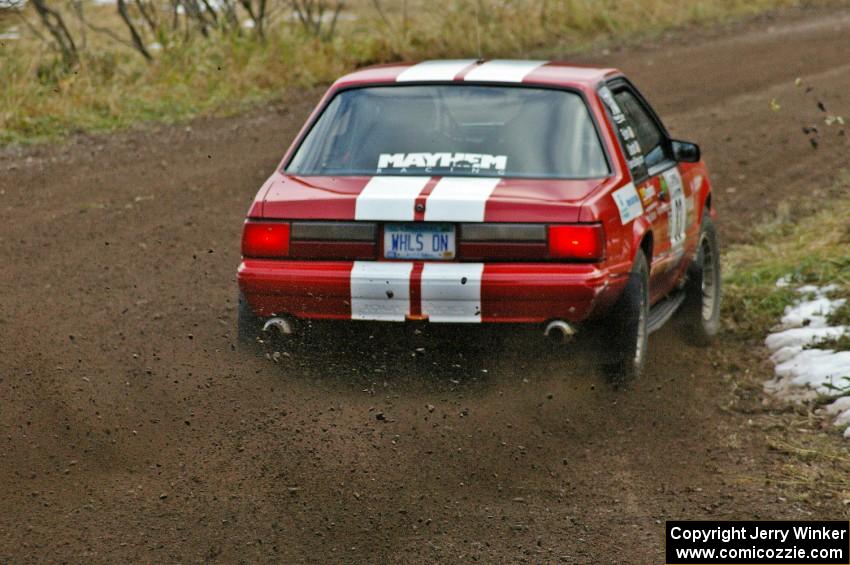 Mark Utecht / Rob Bohn throw rooster-tails off the rear tires on their Ford Mustang on SS1, Herman.