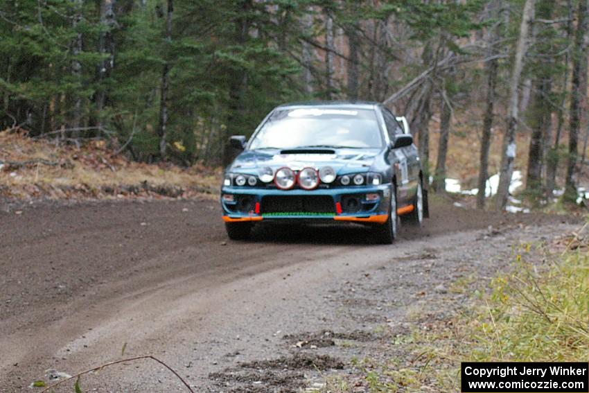 Mark Podoluch / Mariusz Malik at speed through a hard left-hander on SS1, Herman, in their Subaru Impreza.