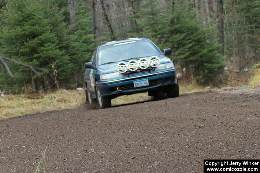 Erick Murray / Nicole Nelson head uphill at a fast left-hander on SS1 in their Subaru Legacy.