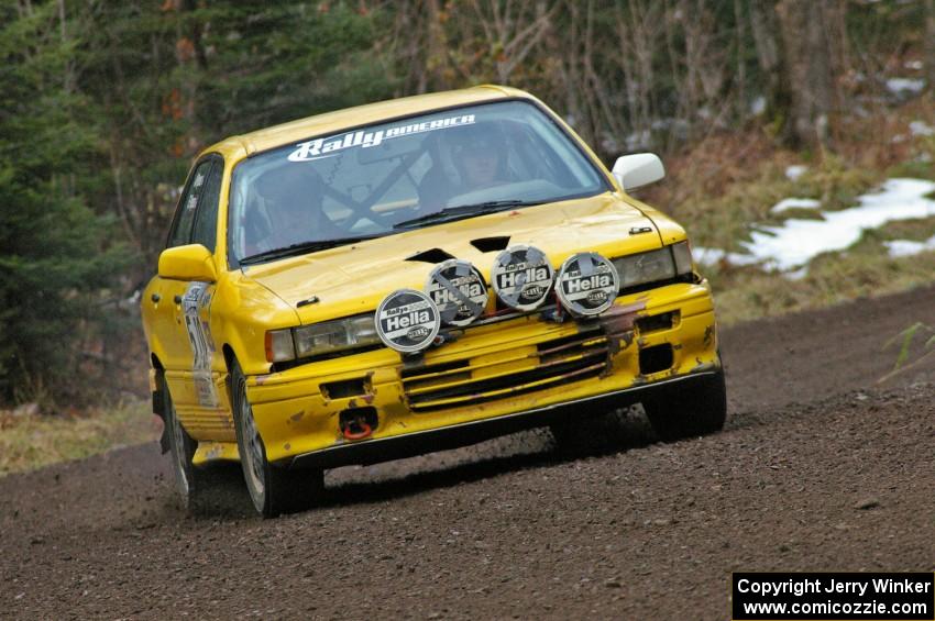 Erik Payeur / Adam Payeur head through a fast sweeping left near the start of SS1, Herman, in their Mitsubishi Galant.