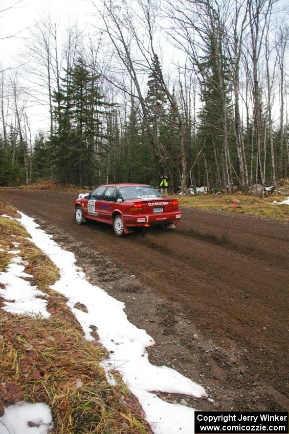 Craig Walli / Jonah Liubakka hang the tail out through the first fast uphill left-hander on Herman, SS1, in their Saturn SL-2.