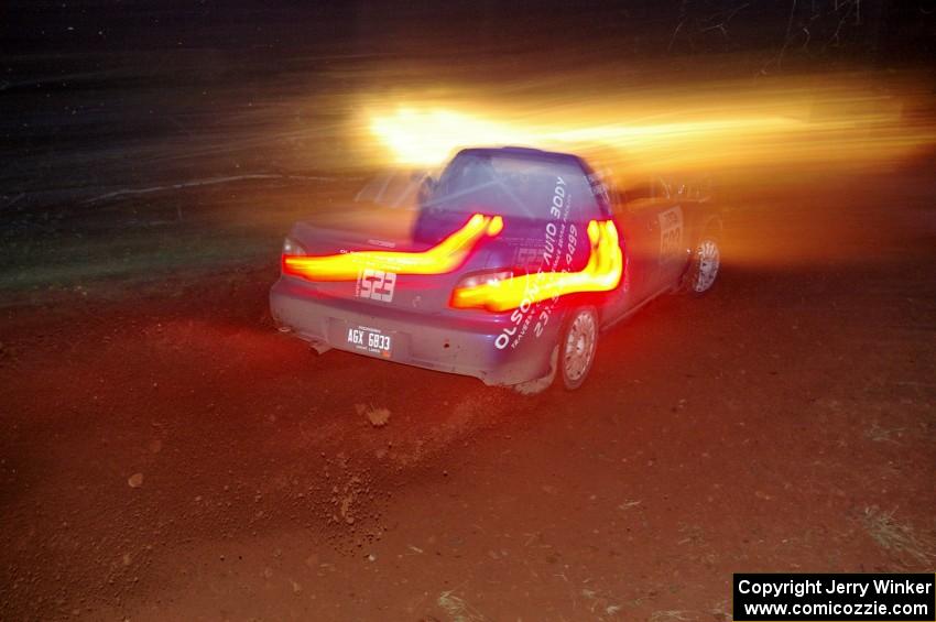 Travis Hanson / Terry Hanson sling gravel and head uphill at the final corner of SS3, Echo Lake 1, in their Subaru WRX.