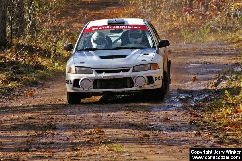 Chris Gilligan / Joe Petersen Mitsubishi Lancer Evo IV heads uphill into the final corner of SS8, Gratiot Lake 1.