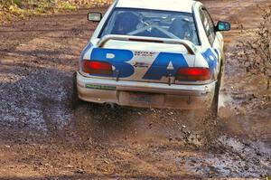 Henry Krolikowski / Cindy Krolikowski hit a puddle at the final corner of Gratiot Lake 1, SS8, in their Subaru WRX.