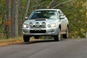 Tom Nelson in the 0 car Subaru Impreza at the midpoint jump on Brockway 1, SS11.