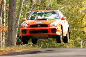 Matthew Johnson / Kim DeMotte caught nice air at the midpoint jump on Brockway, SS11, in their Subaru WRX.