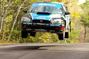 Jonathan Bottoms / Carolyn Bosley catch major air in their Subaru WRX STi at the midpoint jump on SS11, Brockway 1.