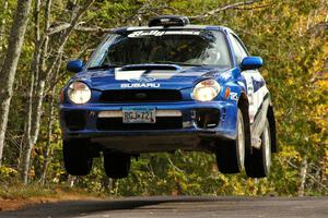 Kyle Sarasin / Stuart Sarasin fly through the air at the midpoint jump on Brockway 1, SS11, in their Subaru WRX.