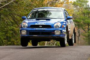 Travis Hanson / Terry Hanson Subaru WRX gets minimal air over the midpoint jump on Brockway 1, SS11.