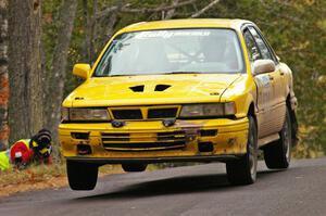 Erik Payeur / Adam Payeur catch minor air at the midpoint jump on Brockway 1, SS11, in their Mitsubishi Galant.