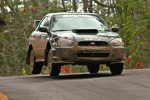 Josh Chang / Jeff Cruzan catch mild air at the midpoint jump on Brockway 1, SS11, in their Subaru WRX STi.