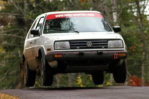 John Hruska / Carl Seidel get a few inches off the ground in their VW GTI at the midpoint jump on Brockway 1, SS11.