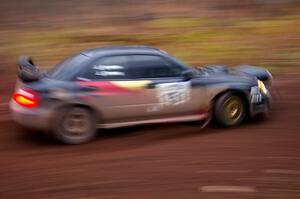 Josh Chang / Jeff Cruzan drift through the first corner of Gratiot Lake 2, SS15, in their Subaru WRX STi.