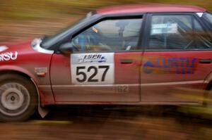 Jonah Liubakka / Craig Walli at speed through the first corner of Gratiot Lake 2, SS15, in their Saturn SL-2.