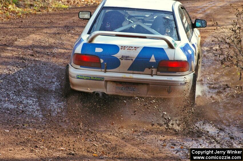 Henry Krolikowski / Cindy Krolikowski hit a puddle at the final corner of Gratiot Lake 1, SS8, in their Subaru WRX.