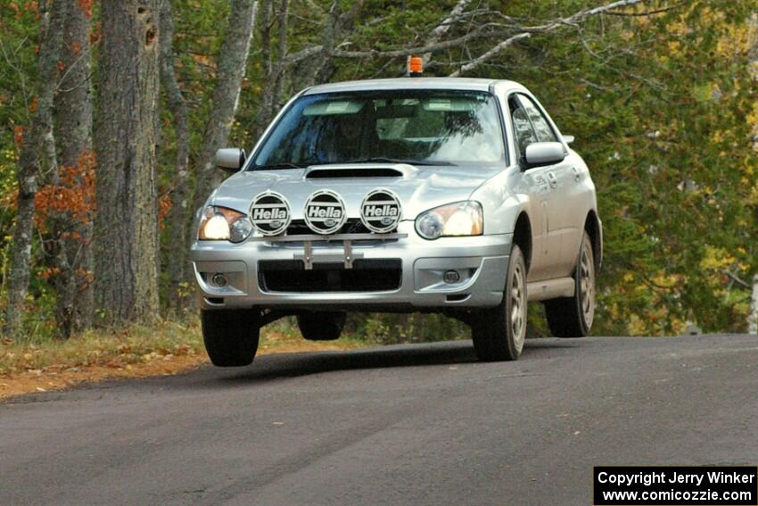 Tom Nelson in the 0 car Subaru Impreza at the midpoint jump on Brockway 1, SS11.