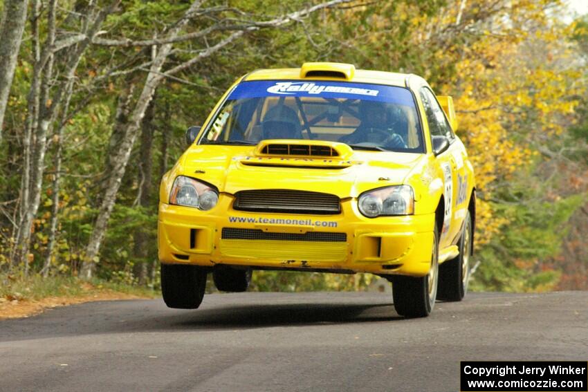 Tim O'Neil / Martin Headland at the midpoint jump on Brockway 1, SS11, in their Subaru WRX STi.