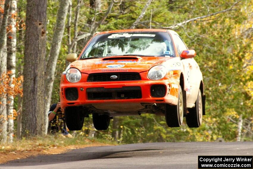 Matthew Johnson / Kim DeMotte caught nice air at the midpoint jump on Brockway, SS11, in their Subaru WRX.