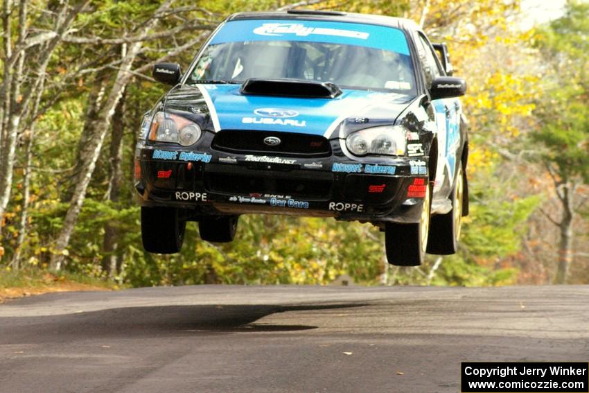 Jonathan Bottoms / Carolyn Bosley catch major air in their Subaru WRX STi at the midpoint jump on SS11, Brockway 1.