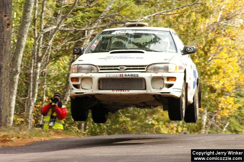 Henry Krolikowski / Cindy Krolikowski get nice air at the midpoint jump on Brockway 1, SS11, in their Subaru WRX.