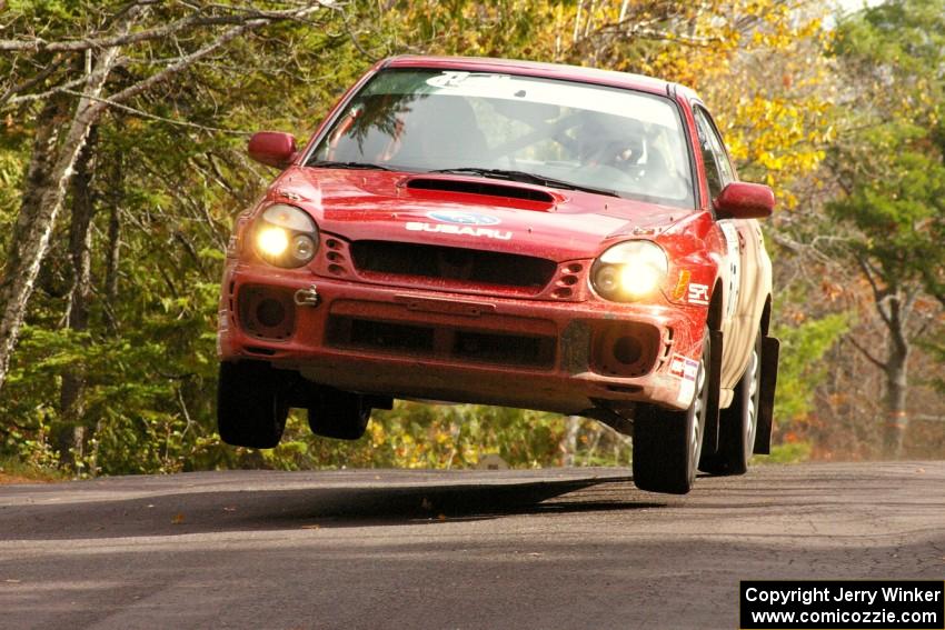 Bryan Pepp / Jerry Stang Subaru WRX at the midpoint jump on Brockway 1, SS11.