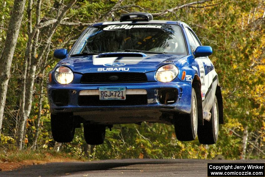 Kyle Sarasin / Stuart Sarasin fly through the air at the midpoint jump on Brockway 1, SS11, in their Subaru WRX.