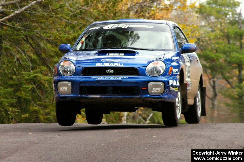 Travis Hanson / Terry Hanson Subaru WRX gets minimal air over the midpoint jump on Brockway 1, SS11.