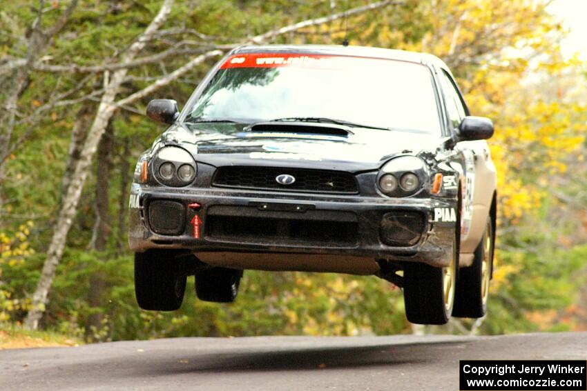 Pat Moro / Mike Rossey catch nice air at the Brockway 1 midpoint jump, SS11, in their Subaru WRX.