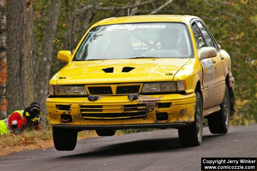 Erik Payeur / Adam Payeur catch minor air at the midpoint jump on Brockway 1, SS11, in their Mitsubishi Galant.