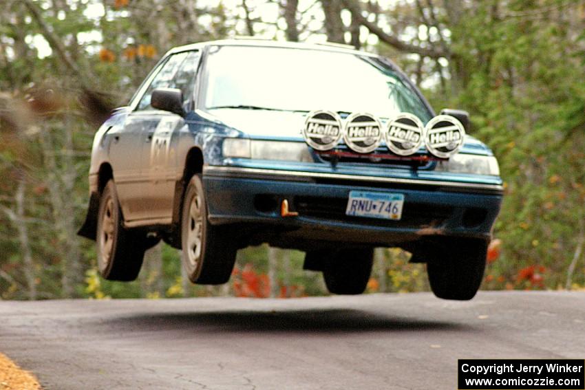 Erick Murray / Nicky Nelson catch nice air over the midpoint jump on Brockway 1, SS11, in their Subaru Legacy.