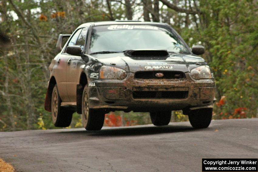 Josh Chang / Jeff Cruzan catch mild air at the midpoint jump on Brockway 1, SS11, in their Subaru WRX STi.