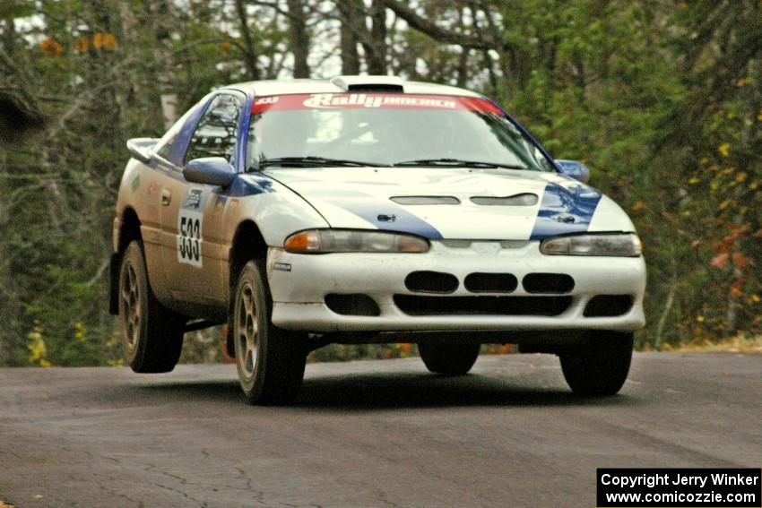 Paul Ritchie / Drew Ritchie catch minor air over the midpoint jump on Brockway 1, SS11, in their Mitsubishi Eclipse GSX.