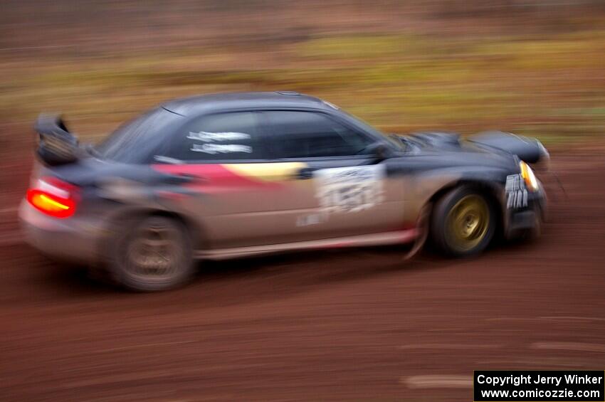 Josh Chang / Jeff Cruzan drift through the first corner of Gratiot Lake 2, SS15, in their Subaru WRX STi.